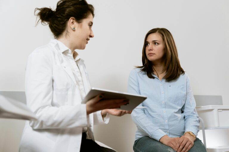 female doctor doing a medical consultation for a female patient. haus of life and co
