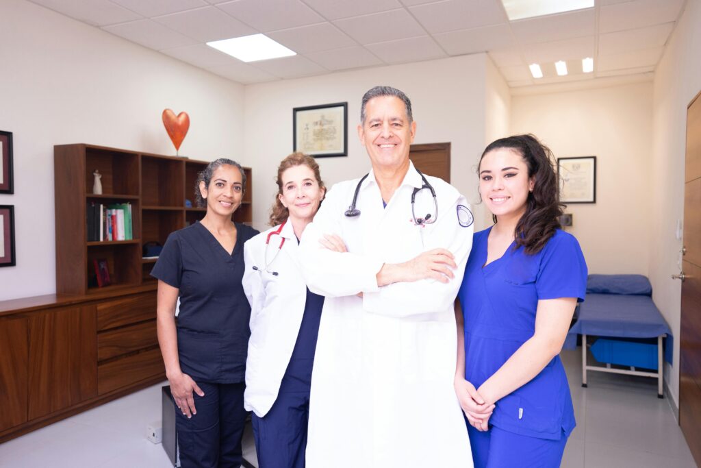group of medical professionals. One male and 3 females. haus of life and co